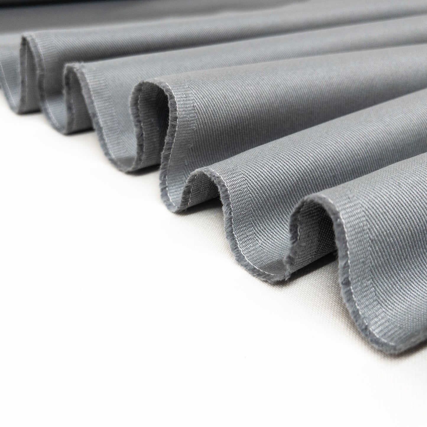 100% cotton bottom weight twill garment fabric folded in a ribbon
