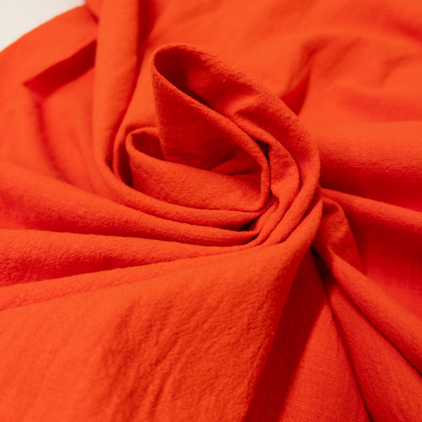 crinkle cotton slub in bright red orange swirled in the center