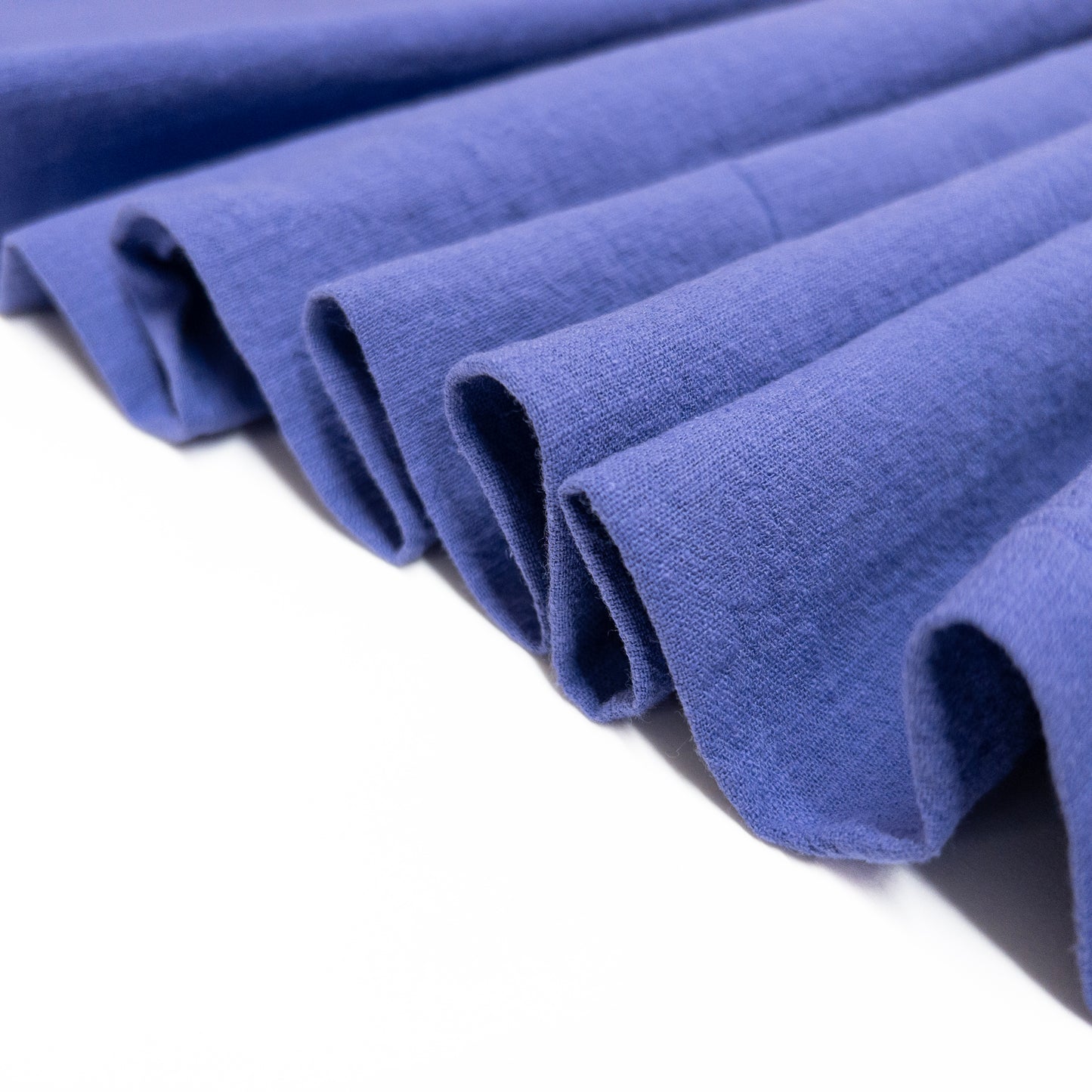 Purple cotton garment fabric folded in a ribbon to show soft drape