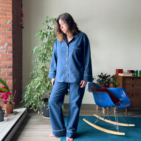 Image of a woman facing forward in the Carolyn Pajamas sewing pattern by Closet Core Patterns.  The fabric is a navy flannel.