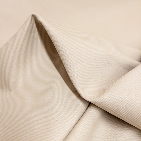 100% cotton bedford cord garment fabric in white shown close up and slightly folded.