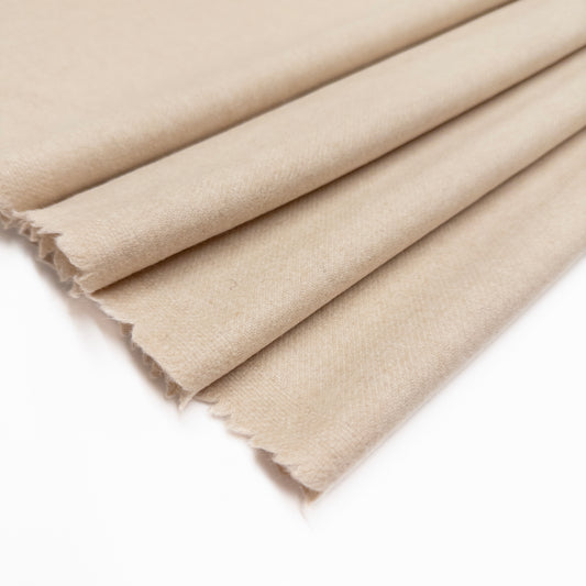 Wool blend Italian suiting in a cream color shown folded from above