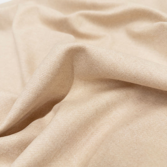 High-quality garment fabric, Italian wool blend suiting in a cream color shown from above