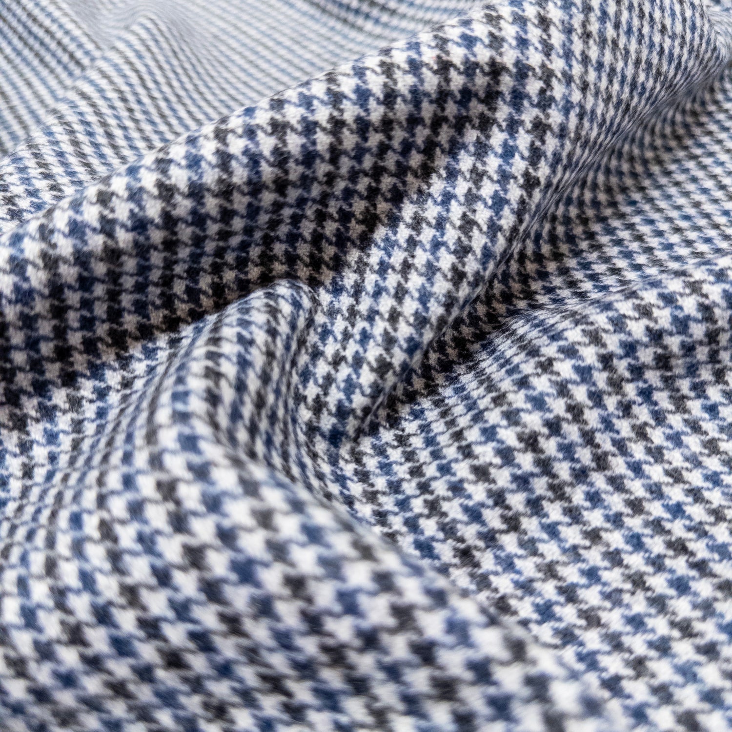 High quality Italian suiting in a houndstooth pattern shown from above