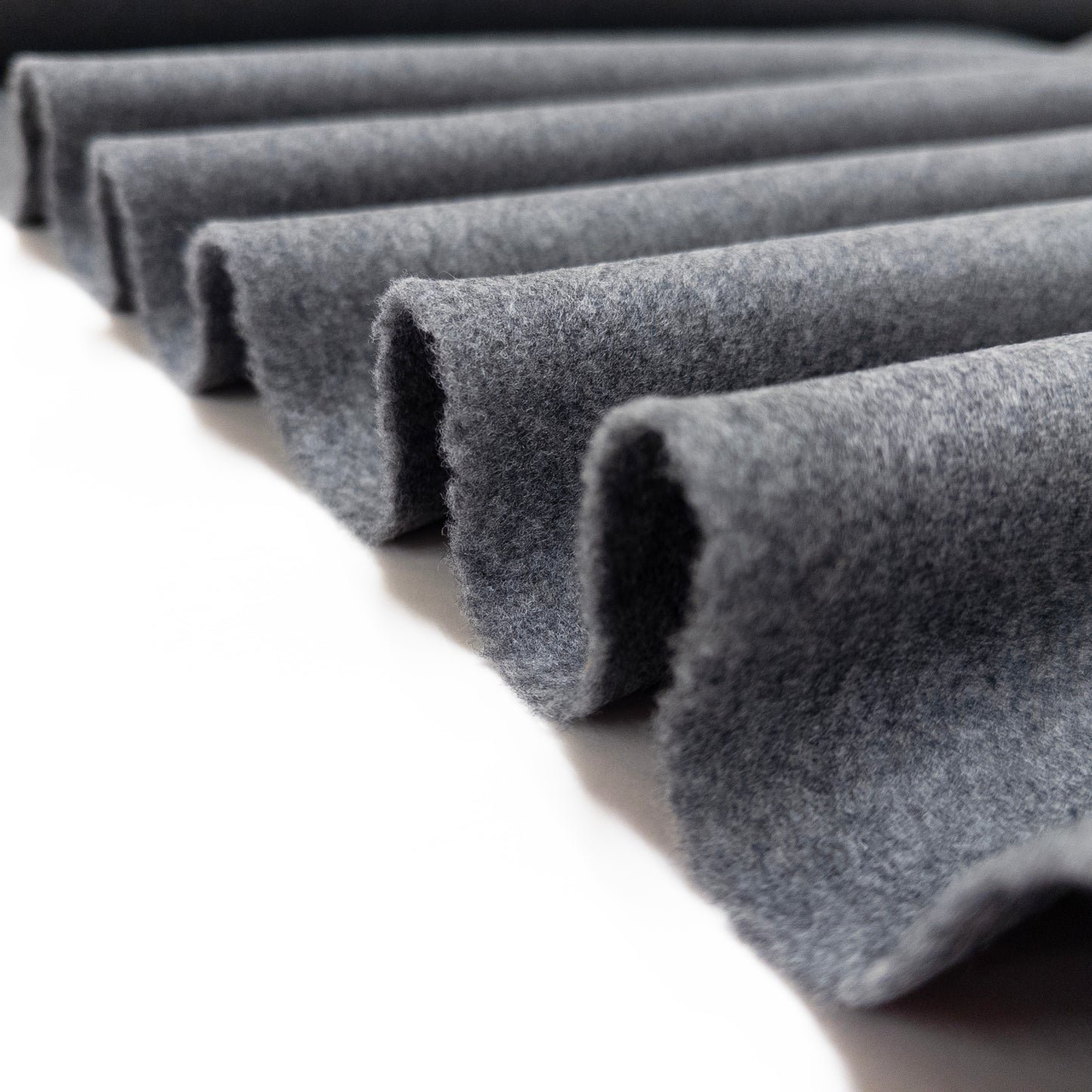 Gray Italian wool coating shown folded in a ribbon