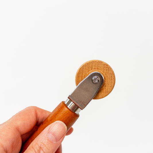 Wood seam roller for pressing seams in a side view.