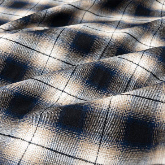 quality cotton flannel in blue shown from above to illustrate plaid pattern.