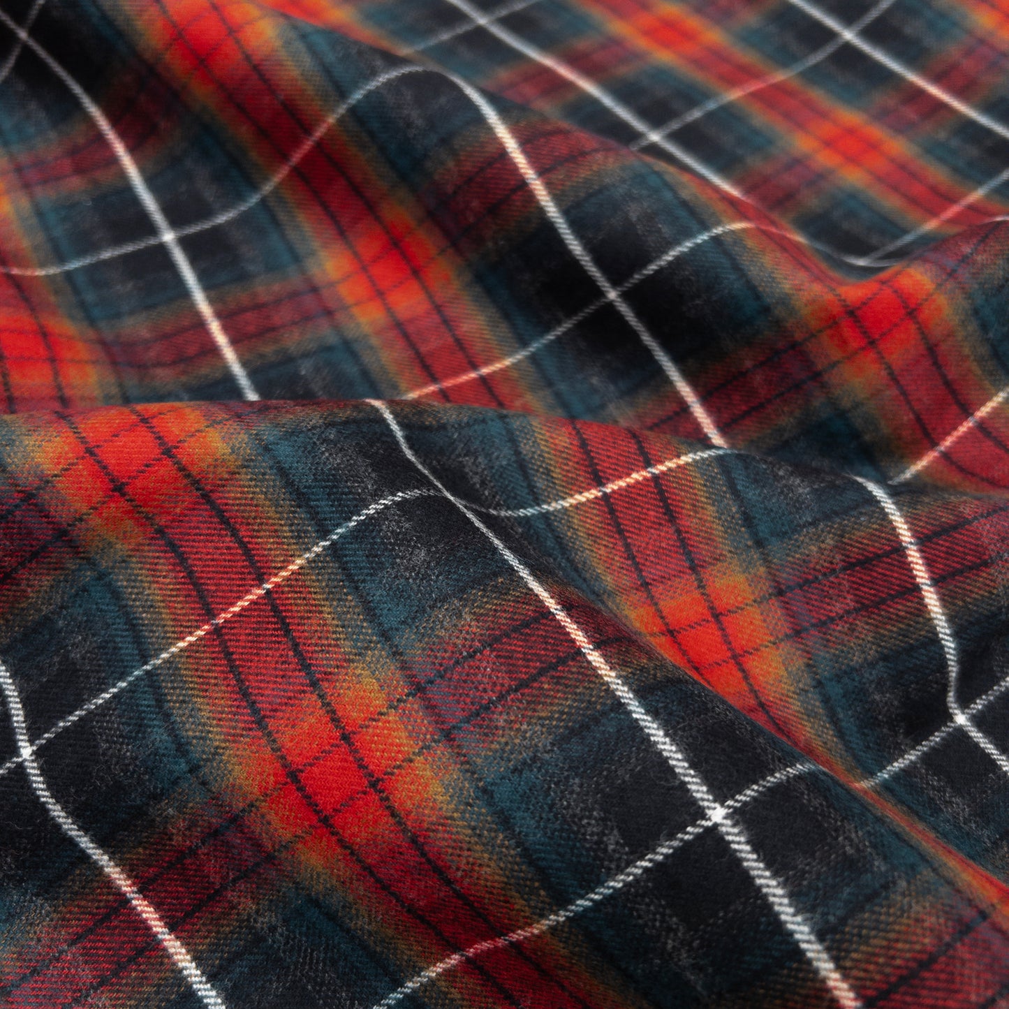 Cotton flannel in red to dark plaid with a brushed face shown from above.