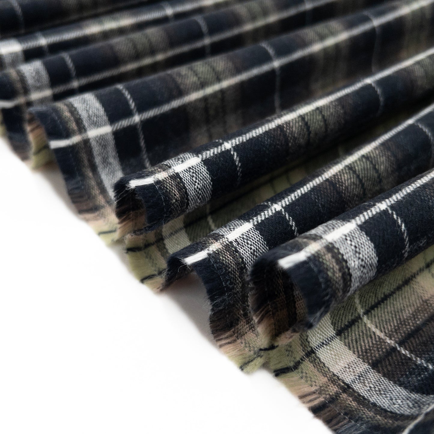 Plaid cotton flannel clothing fabric shown folded in a ribbon.