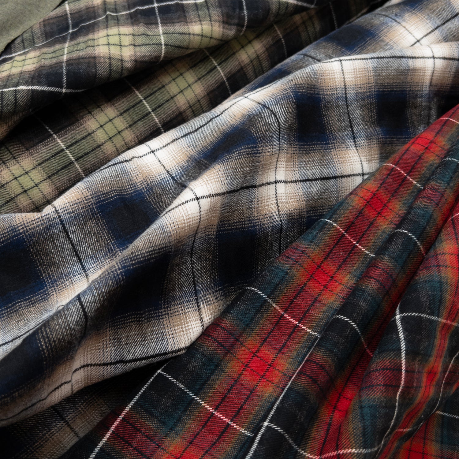 Image of three high quality flannel fabrics for making clothing shown from above.