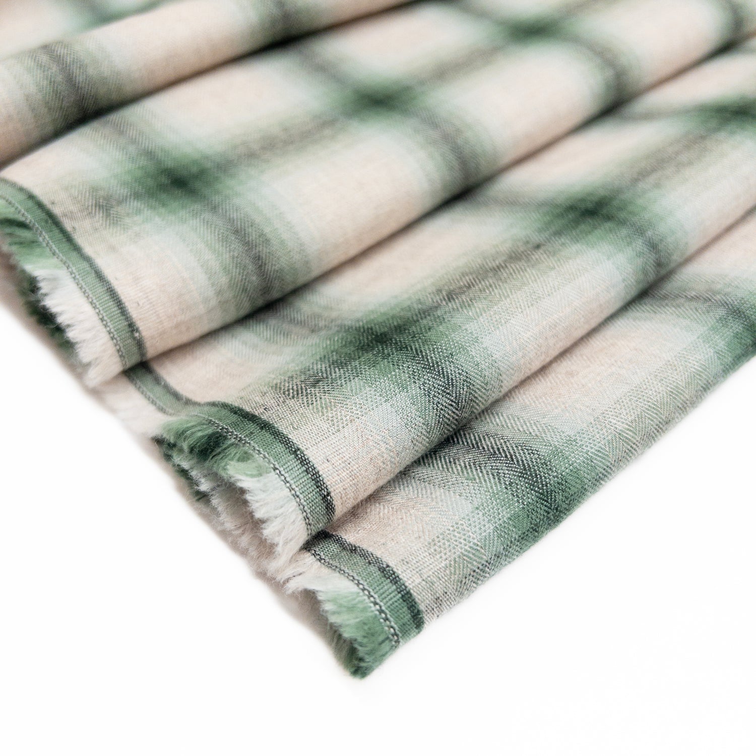 Lightweight cotton shirting garment fabric in mineral green shown folded