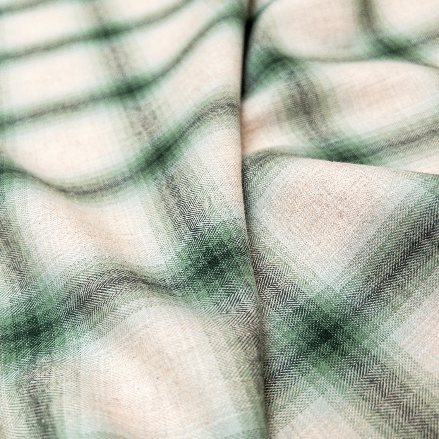 View of the fabric face with folds to show fabrics plaid grid pattern and soft drape