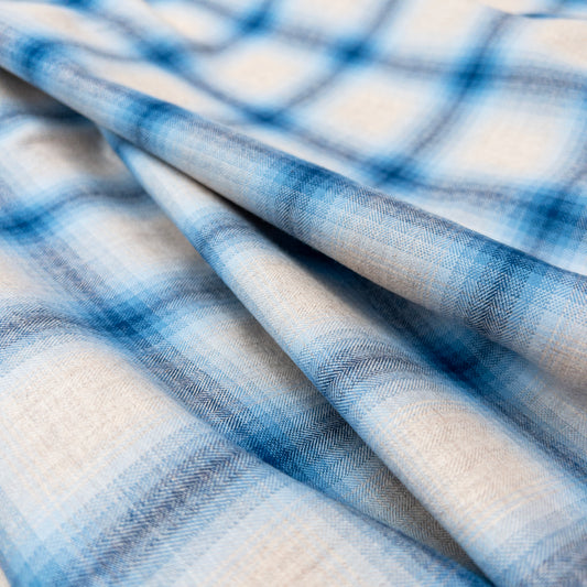 Surface view of the Fade In River Bed garment fabric illustrating the herringbone weave in yarn dyed blues and natural colors