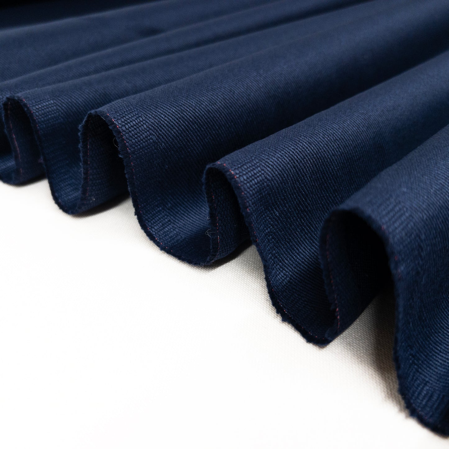 Bottom weight twill shown folded in a ribbon to illustrate fabric structure