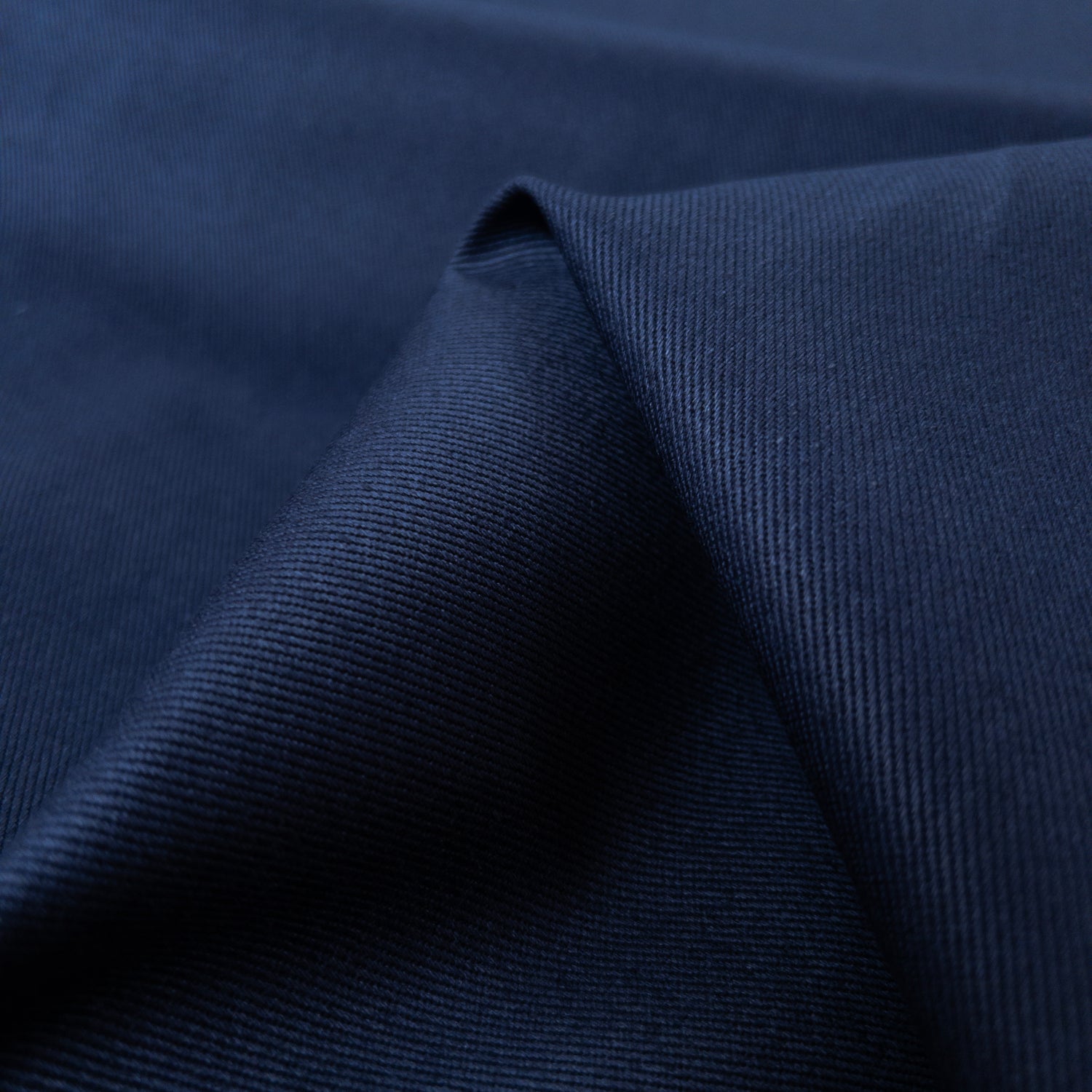 Close up view of heavy weight cotton twill weave with diagonal ribs in blue