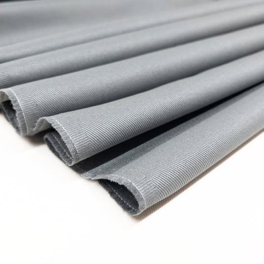 100% cotton twill garment fabric in a cool grey color folded