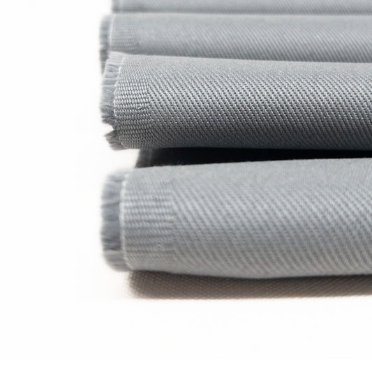 Detail view of heavy weight cotton twill apparel fabric showing the diagonal ribs on the fabric face