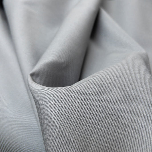 Close up view of heavy twill with deep diagonal ribs in a cool grey