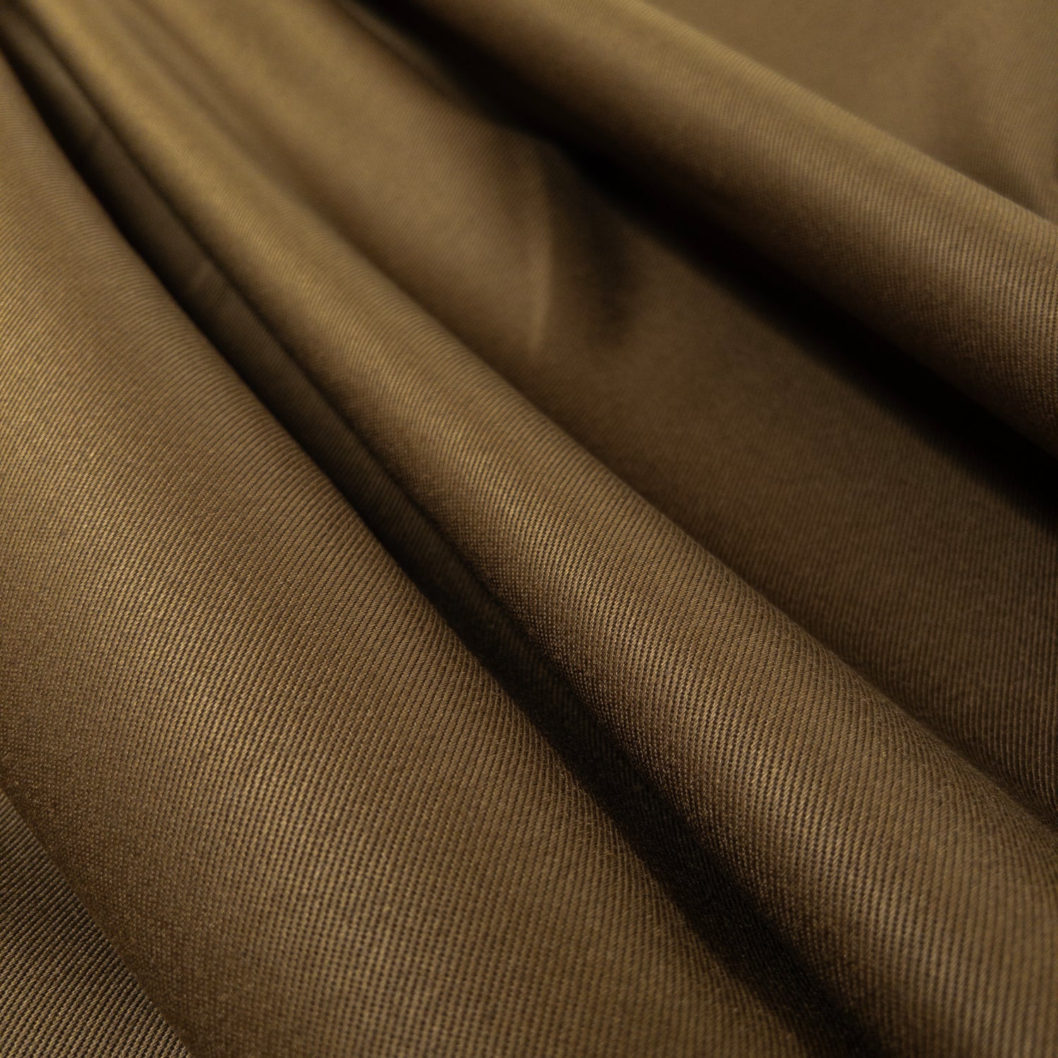 View from above of heavy cotton twill apparel fabric in a deep olive green