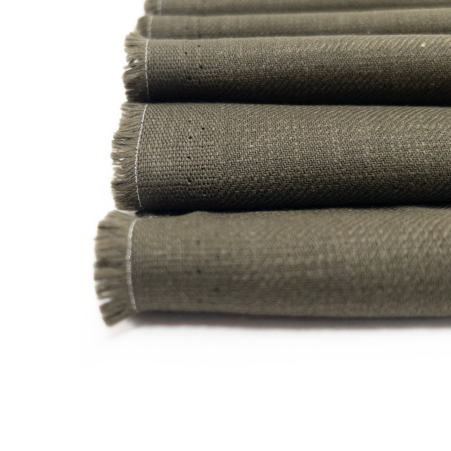 Close up view of garment fabrics slub texture surface in an olive green.