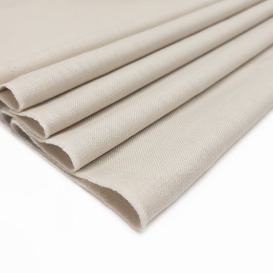 100% European cotton slub garment fabric in a soft white shown folded.