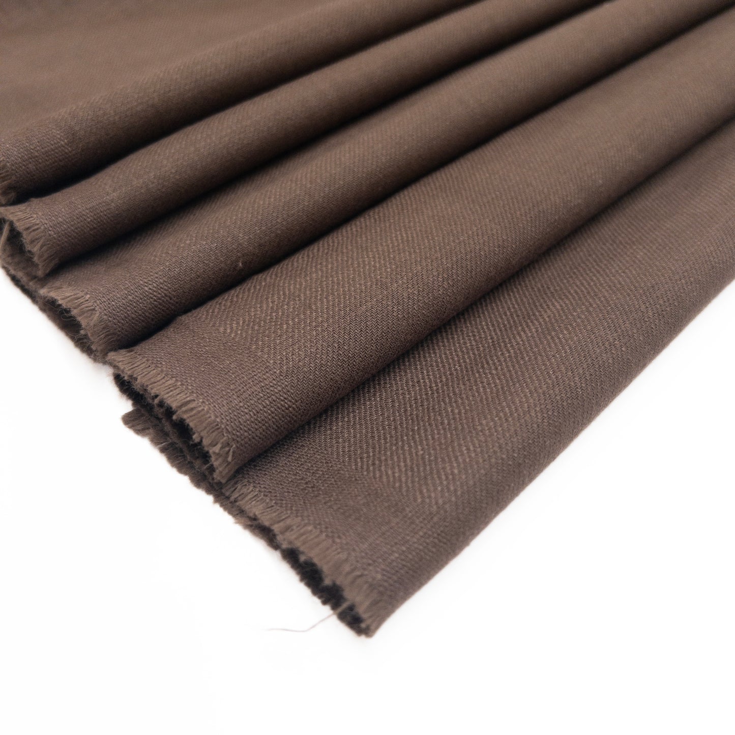 European cotton garment fabric features a slub texture shown folded.