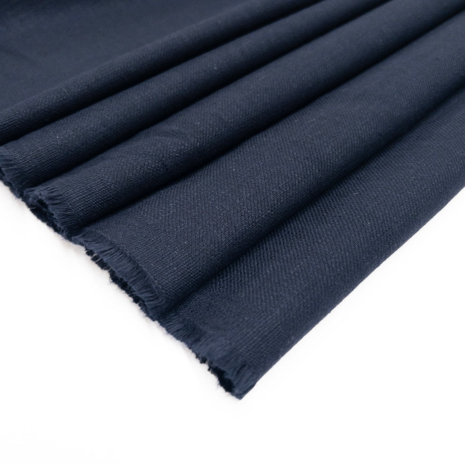 Navy shirting fabric in cotton with a slub textue shown folded.