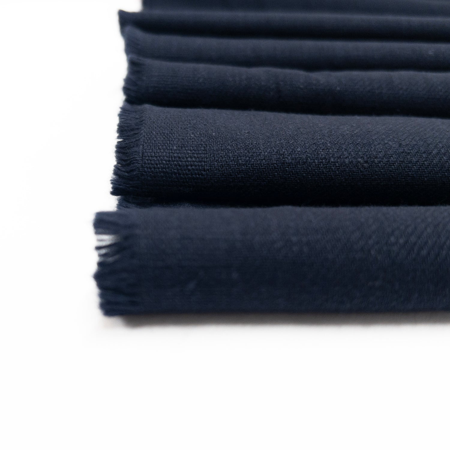 Detail view of cotton fabric with a slub texture in navy blue.