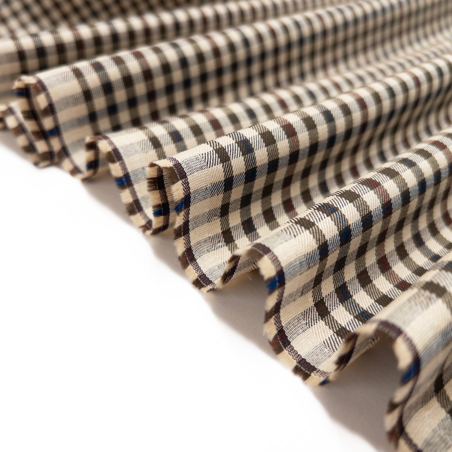 Shirting garment fabric shown folded in a ribbon to display soft drape of fabric.