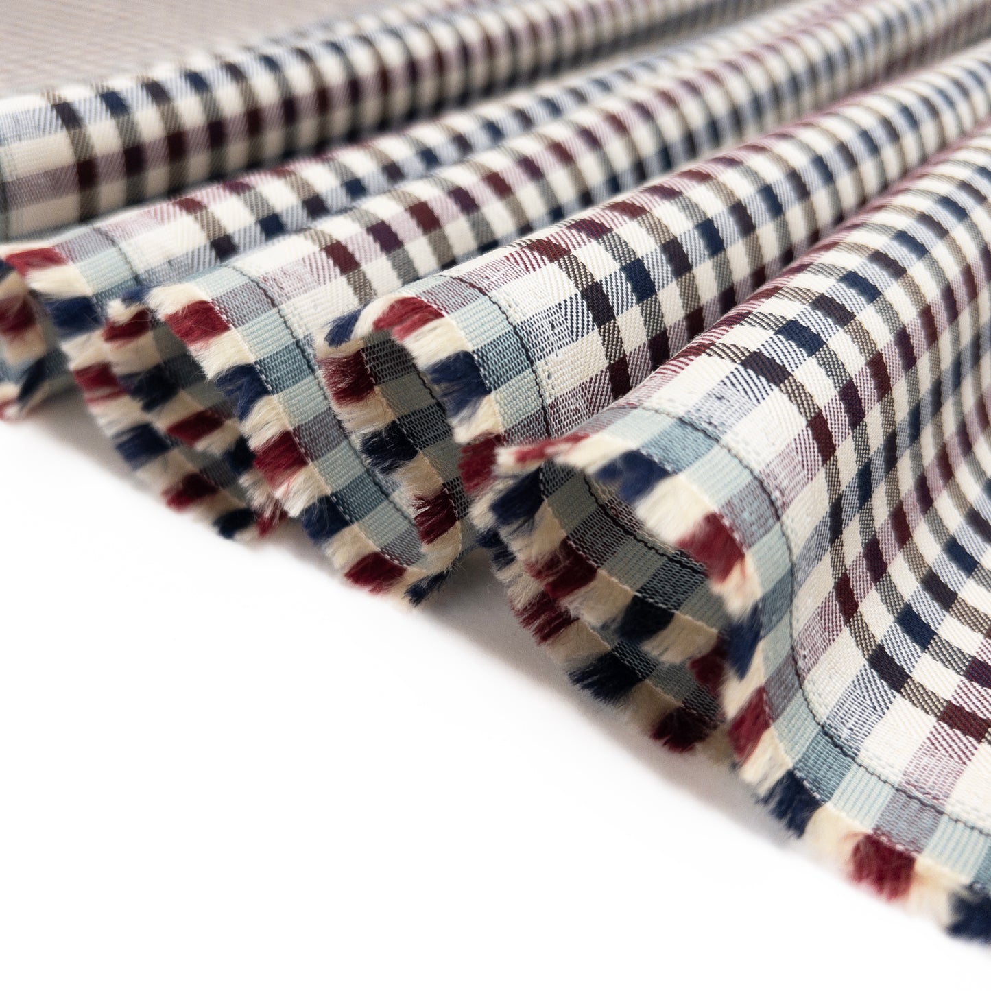 100% cotton shirting from Spain is shown folded in a ribbon.