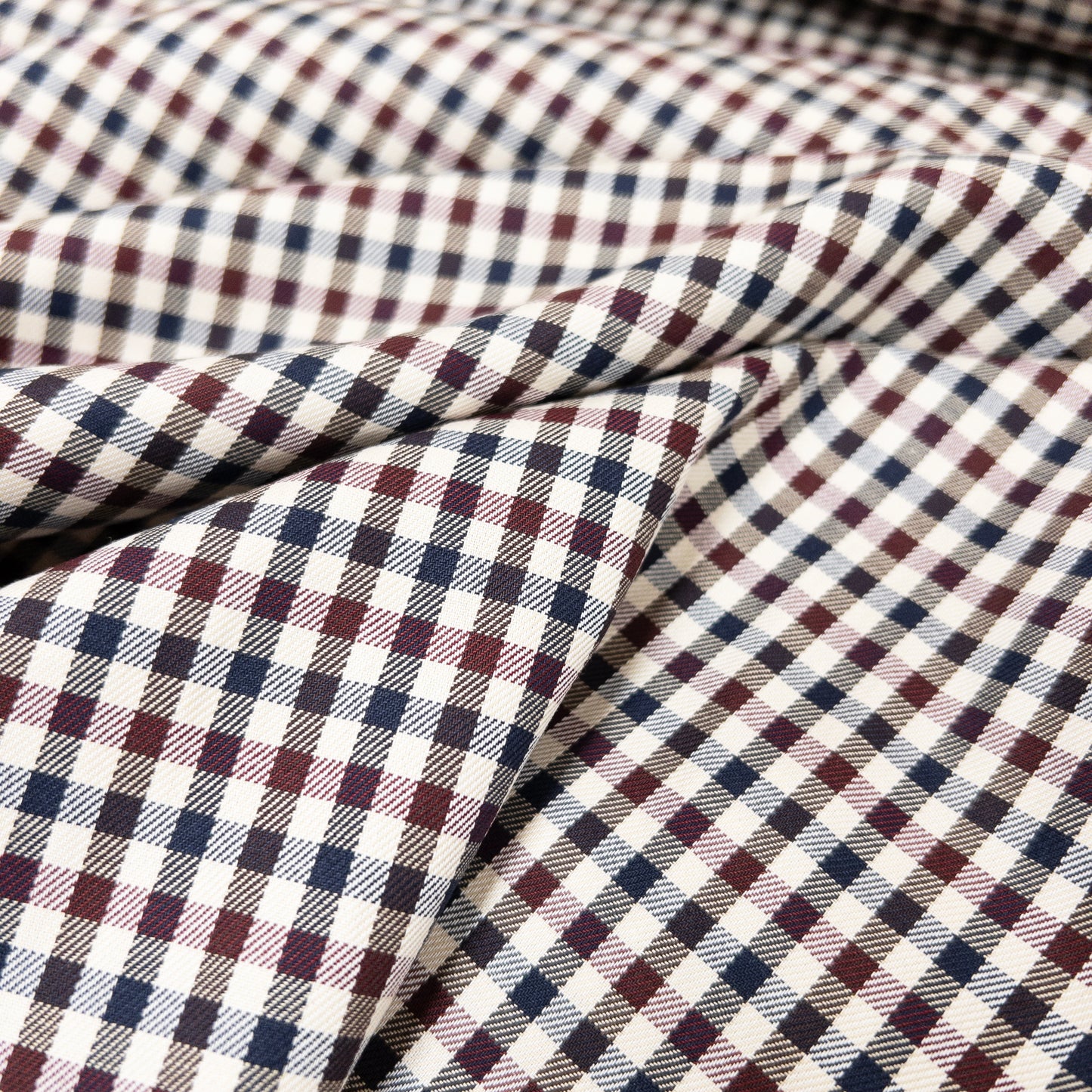 Apparel fabric shown from above is lightweight cotton with a small check pattern.