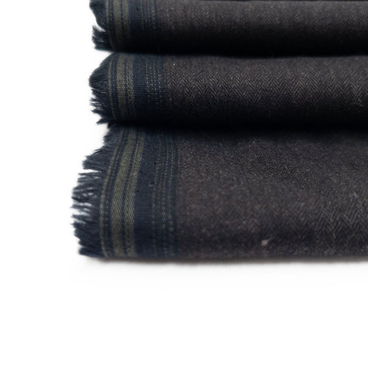 Detail view of cotton flannel in a dark grey with a herringbone weave.