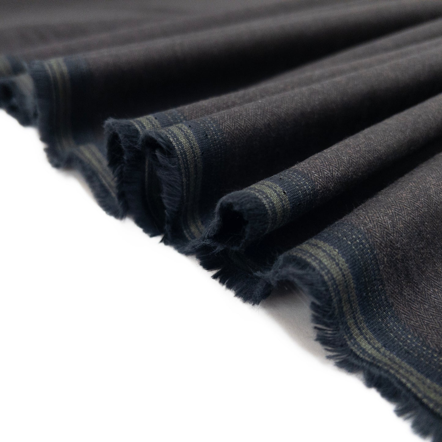 Wool like cotton flannel with a brushed face in dark shown folded in a ribbon.