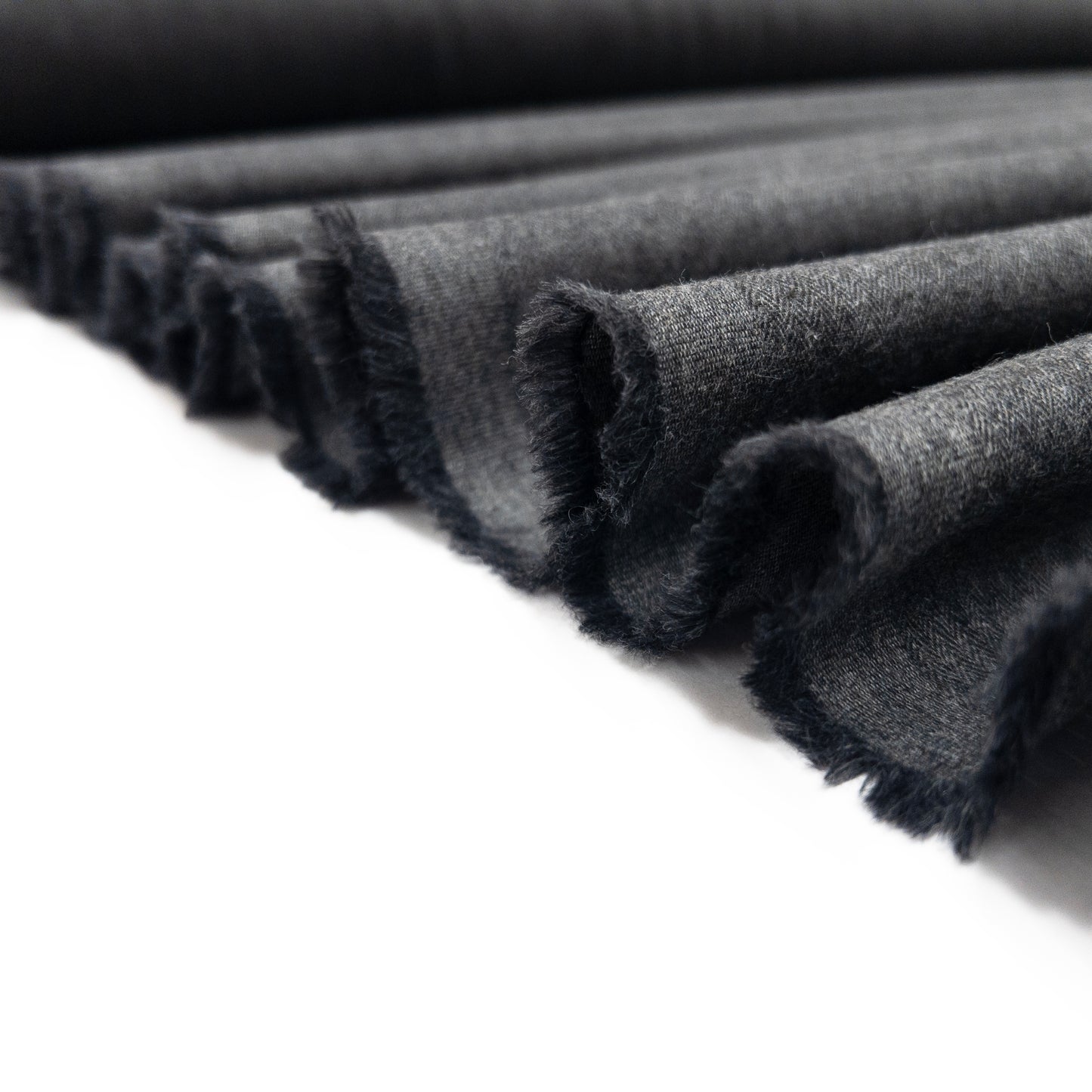 Quality cotton flannel in a dark grey shown folded in a ribbon.