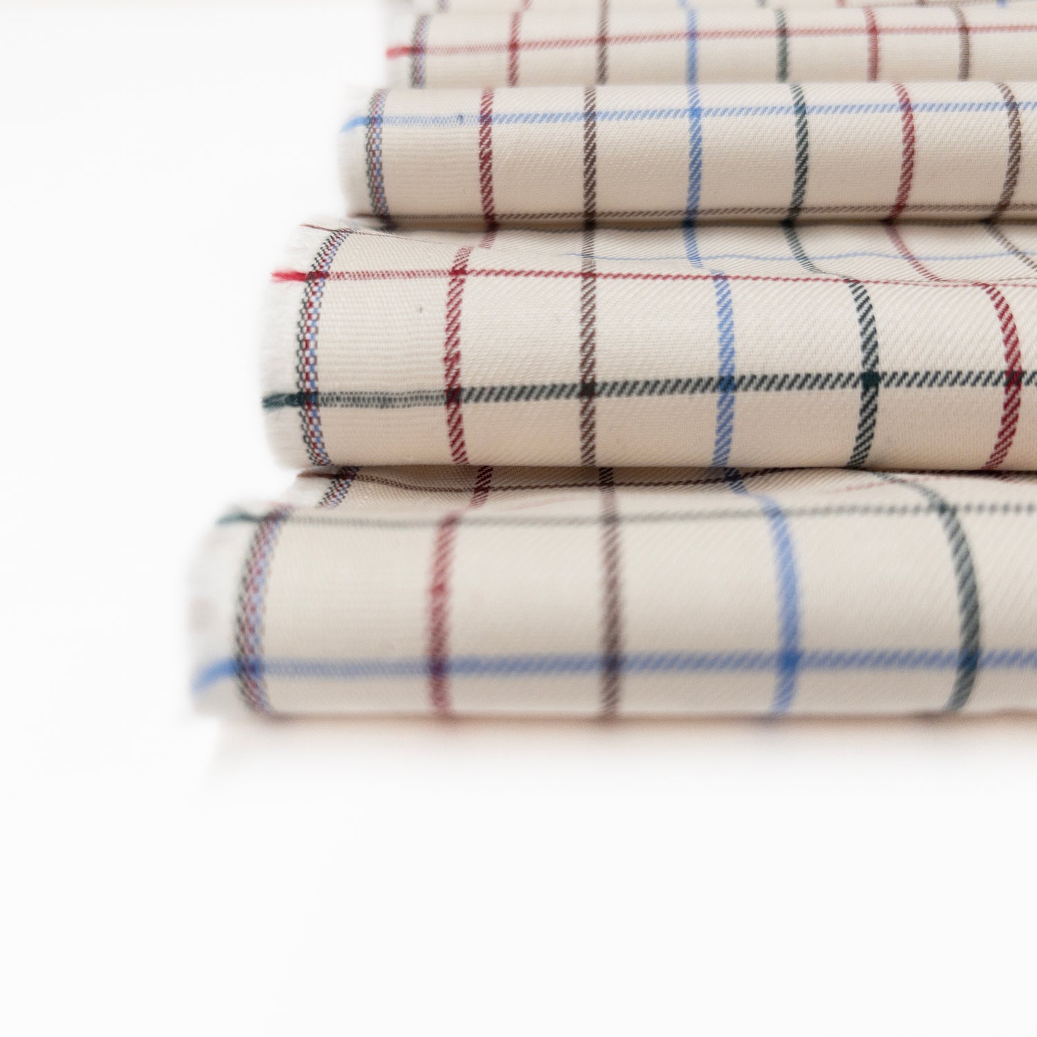 Tattersall Plaid garment fabric in 100% cotton twill weave shown in a detail view.