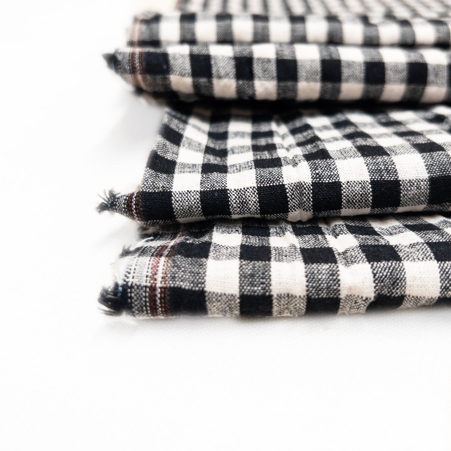 This detail image is of a black and natural yarn gingham fabric.