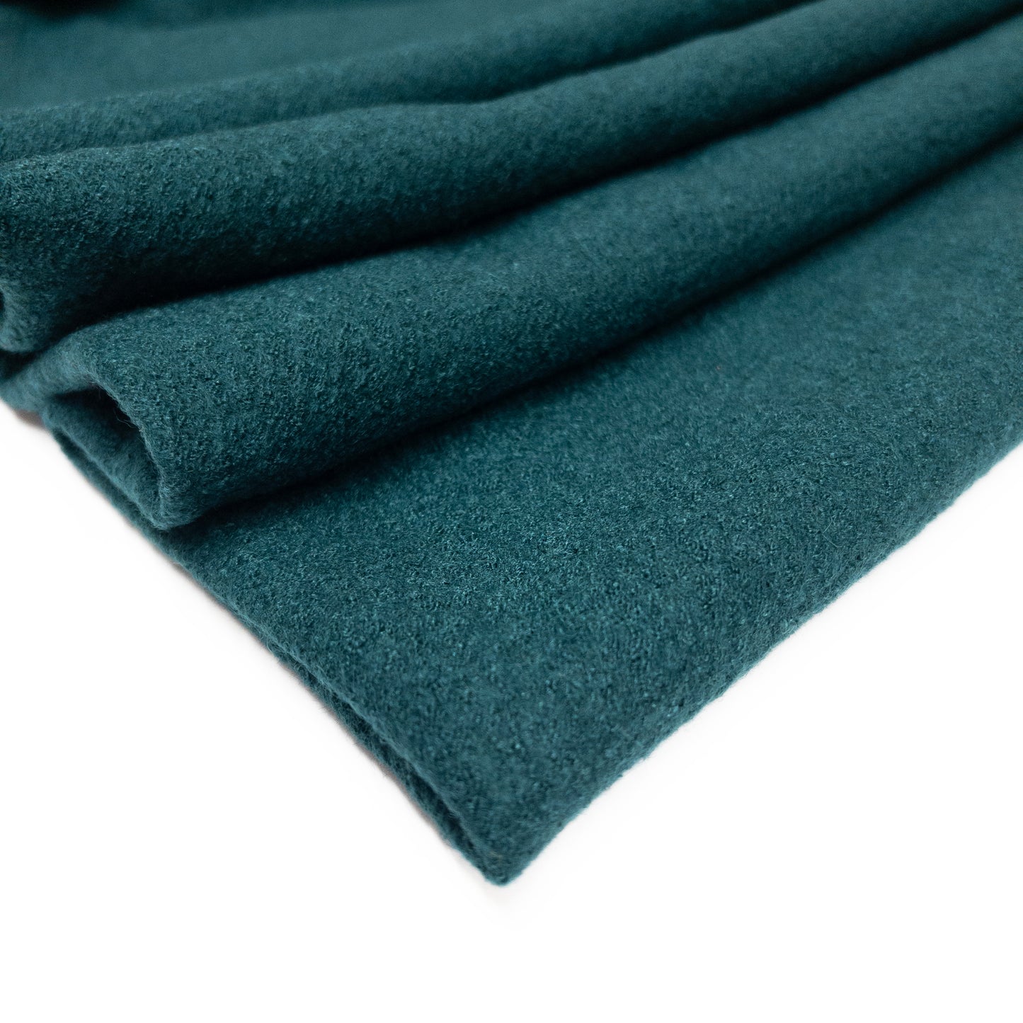 boiled wool and viscose garment fabric in a blue green color pictured folded