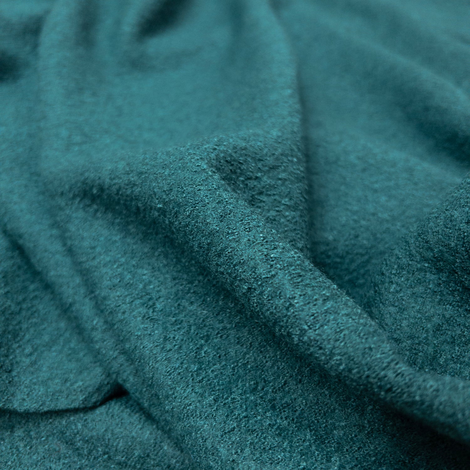 Boiled wool and viscose apparel fabric in blue green with a textured face.