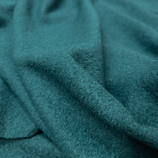 Boiled wool and viscose apparel fabric in blue green with a textured face.