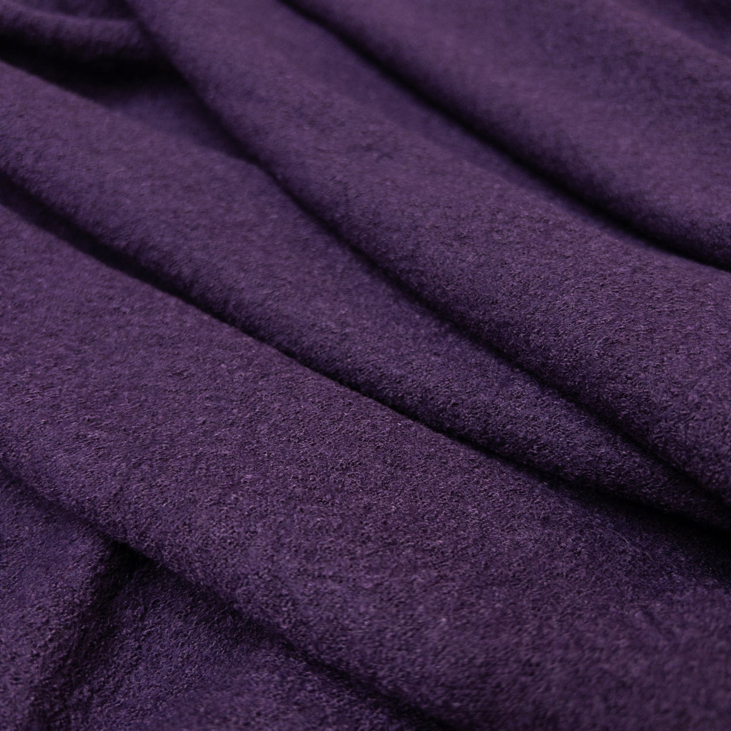 Boiled wool fabric in purple with a textured face.