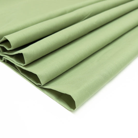 100% cotton voile fabric in an herb green hue shown from above folded over itsef