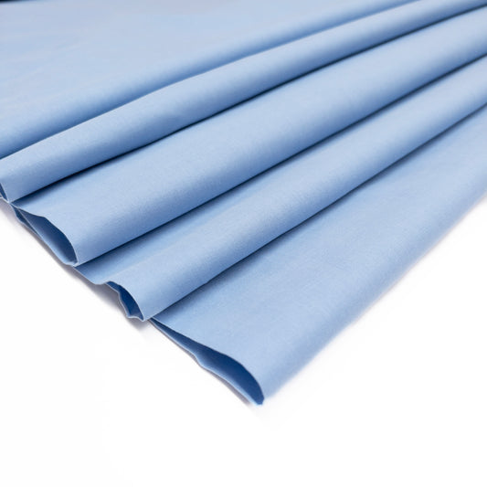 Very lightweight cotton voile garment fabric shown folded on itself.