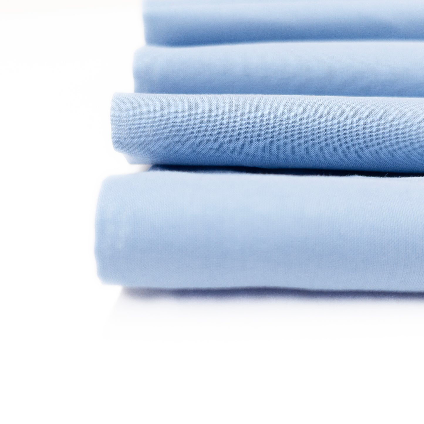 Detail view of crisp lightweight cotton voild fabric in a pale blue.