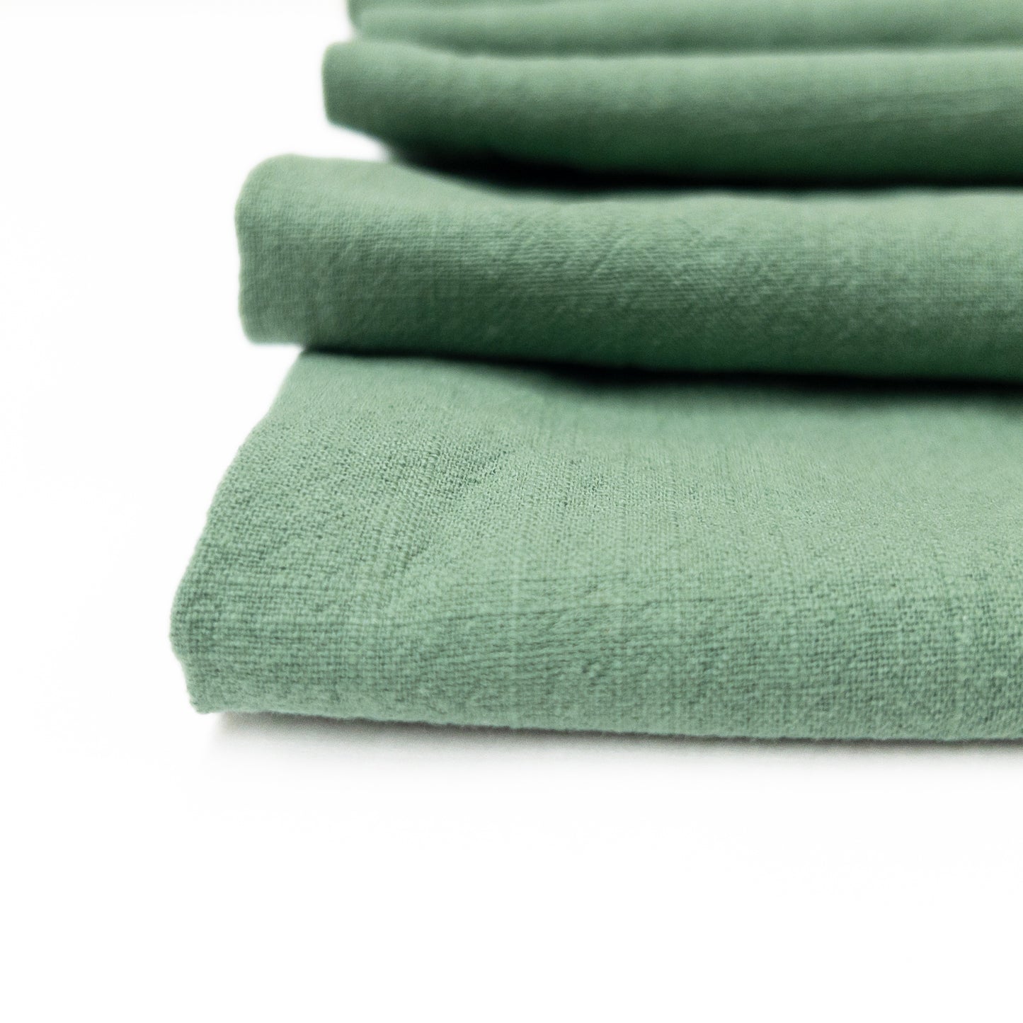 close up view of the textured surface on this muted green apparel fabric