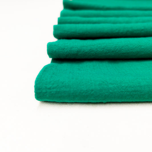 detail photo of jewel green shirting fabric illustrating slub texture