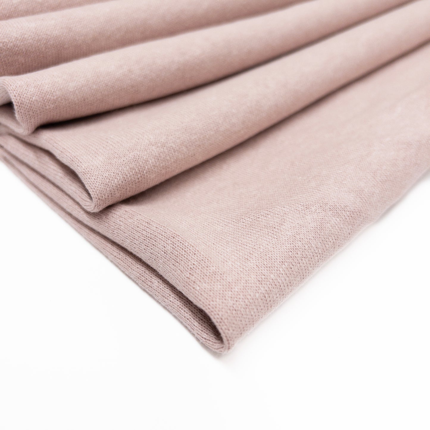 Fleece back knit fabric in a pale blush of organic cotton, hemp and bamboo sown folded.