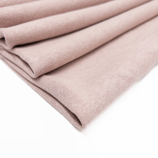 Fleece back knit fabric in a pale blush of organic cotton, hemp and bamboo sown folded.