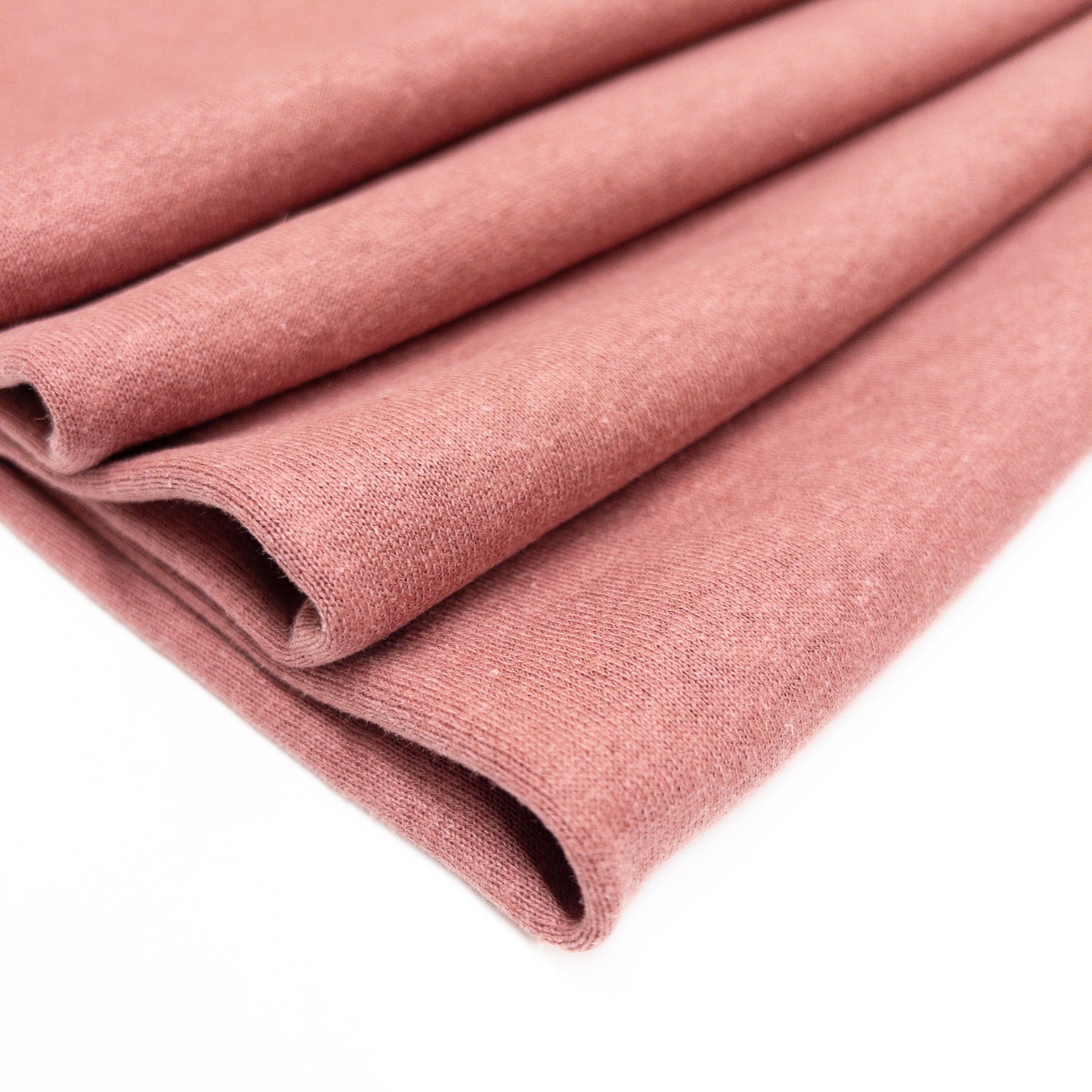 Organic cotton fleece in a blush pink shown folded.