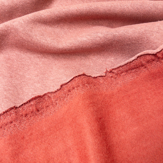 Fleece back folded over knit face of this organic cotton garment fabric in pink.