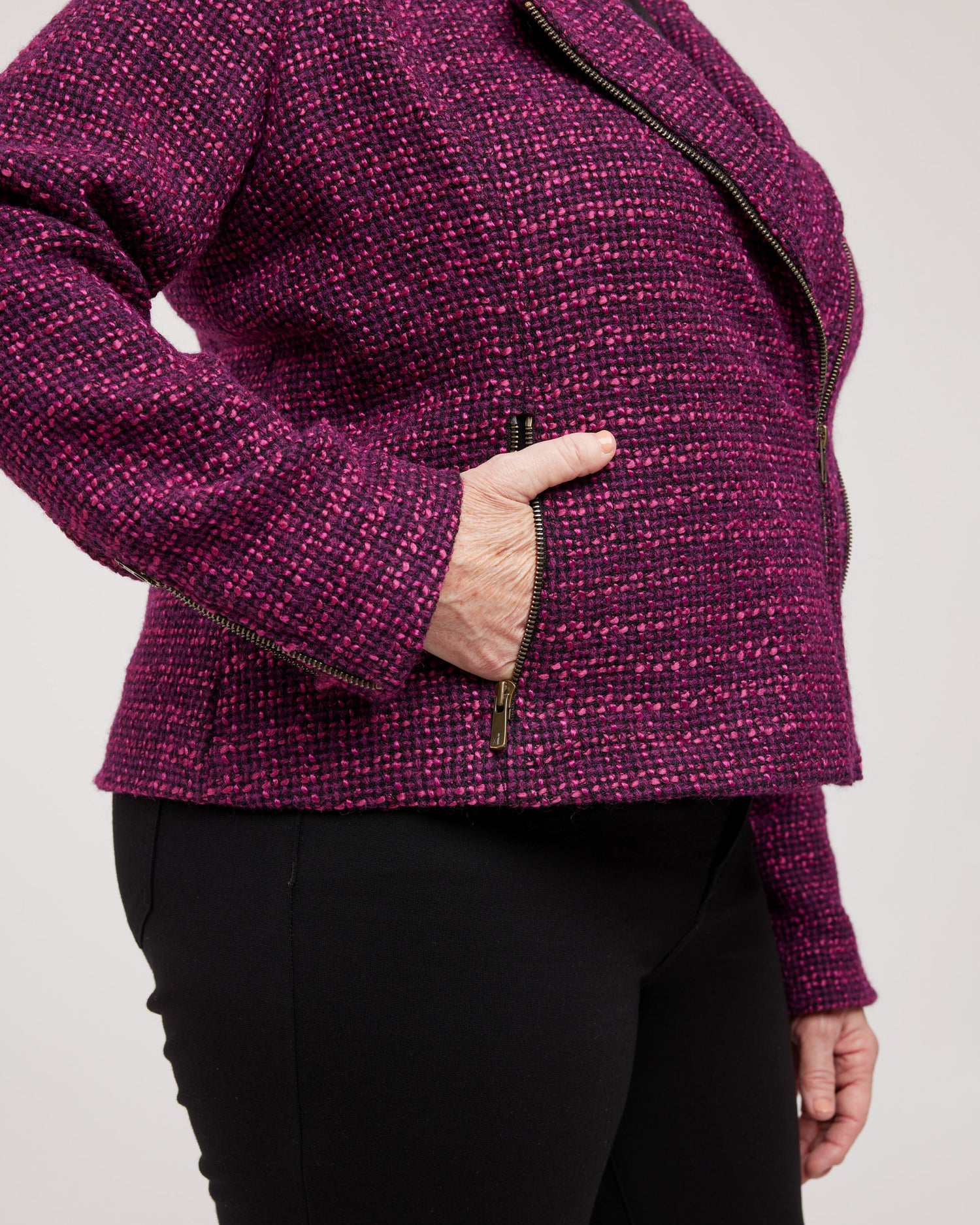 Person wearing a purple textured jacket with a plain background. This biker jacket is the Canton Moto Jacket sewing pattern from Cashmerette.